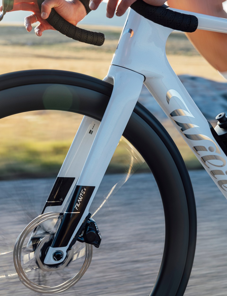 Rider climbing on a white Wilier road bike